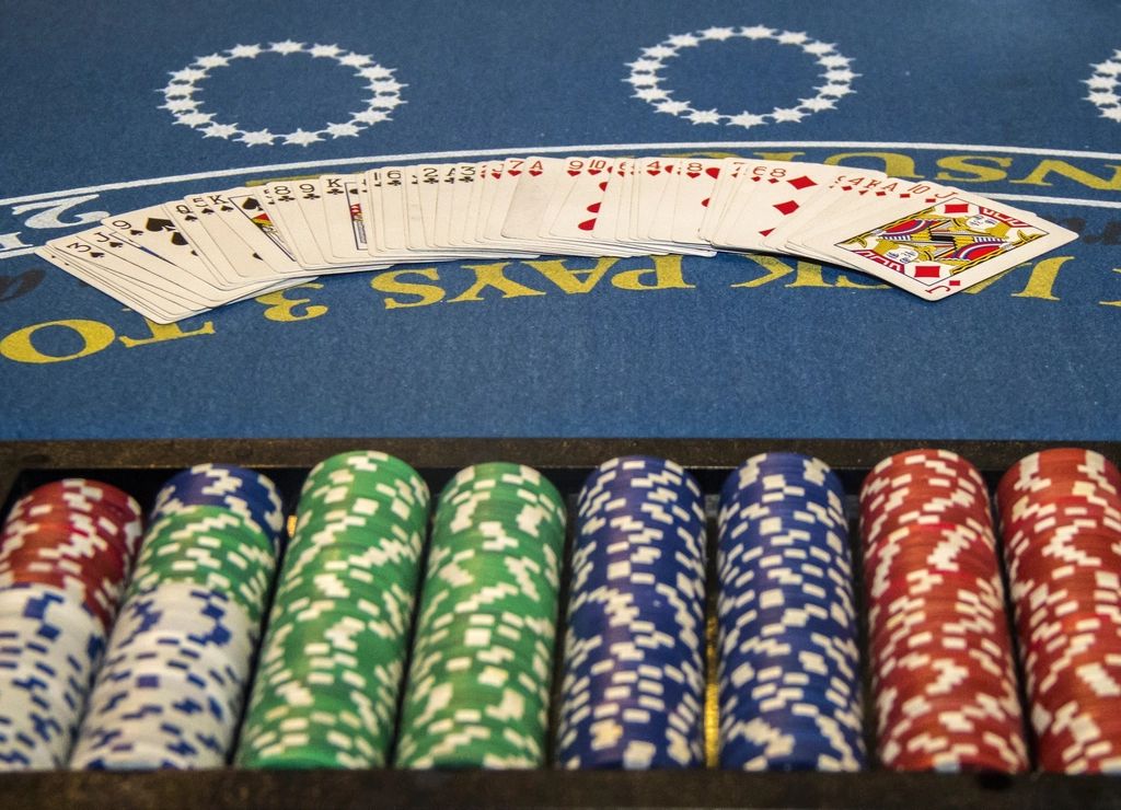 Gaming chips and cards on the table felt