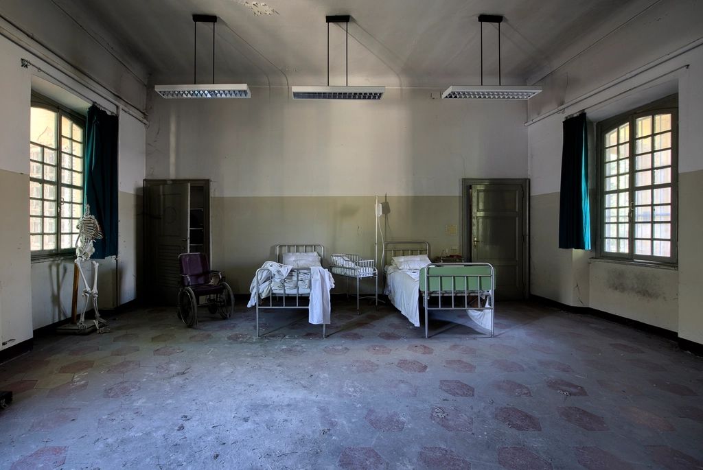 A guest room with two beds and a window